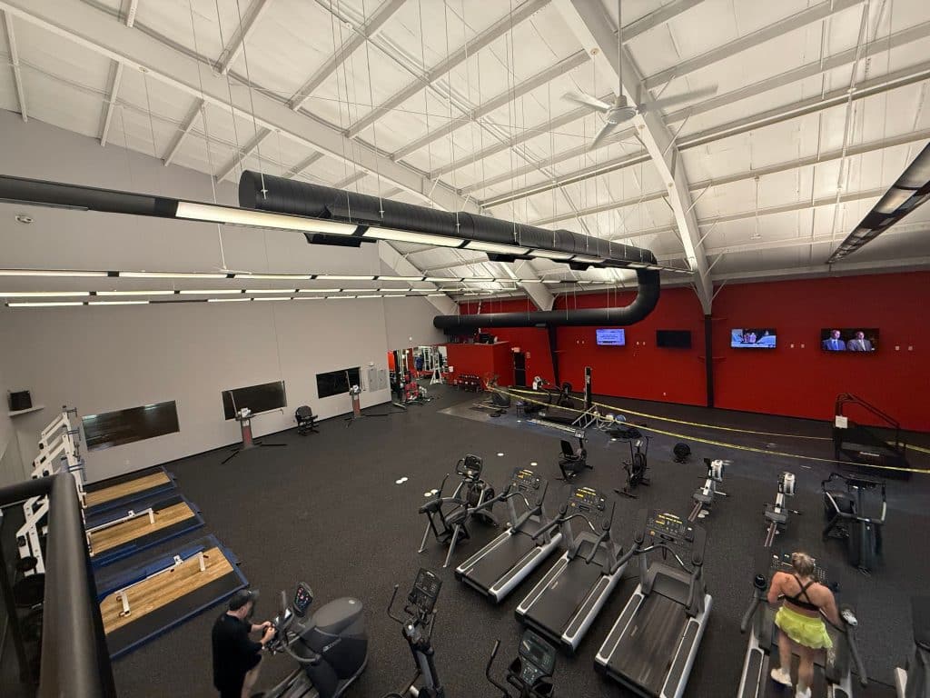 open gym with treadmills, people working out